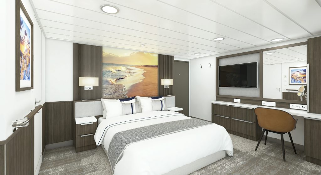King bed, desk & chair and flat screen TV in a Balcony Stateroom Superior on Douglas Mawson.
