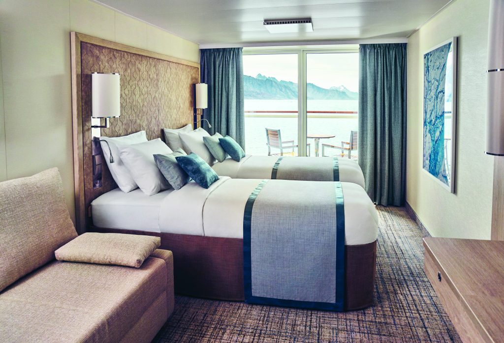 Couch, two twin beds and huge windows.