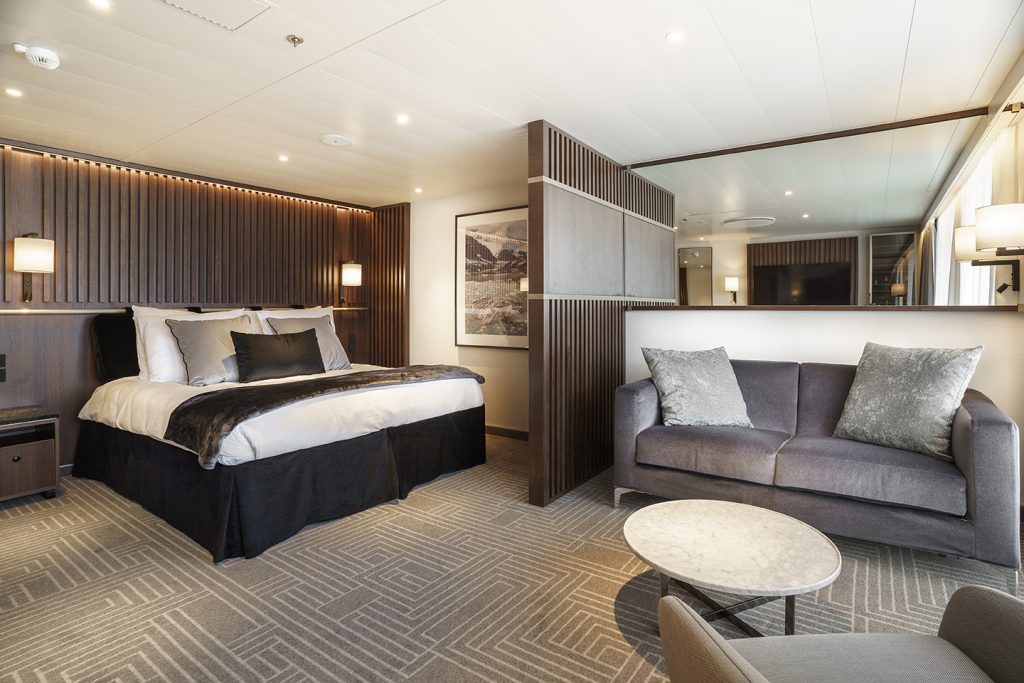 Penthouse Suite on Ultramarine with double bed, couch and chair.