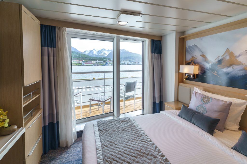 View from double bed looking out glass sliding door to the sea.