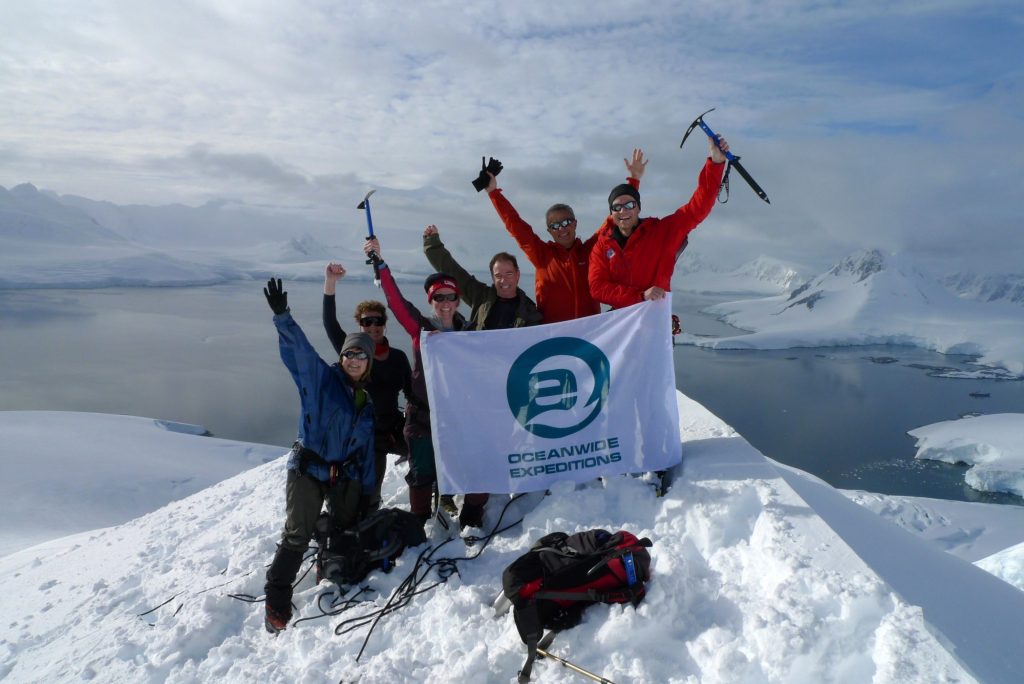 group of people on a snowy mountain submit in Antarctica