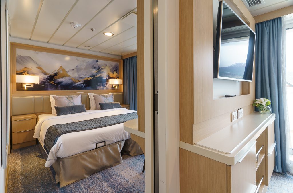 View looking into bedroom with a double bed in penthouse suite on Ocean Explorer