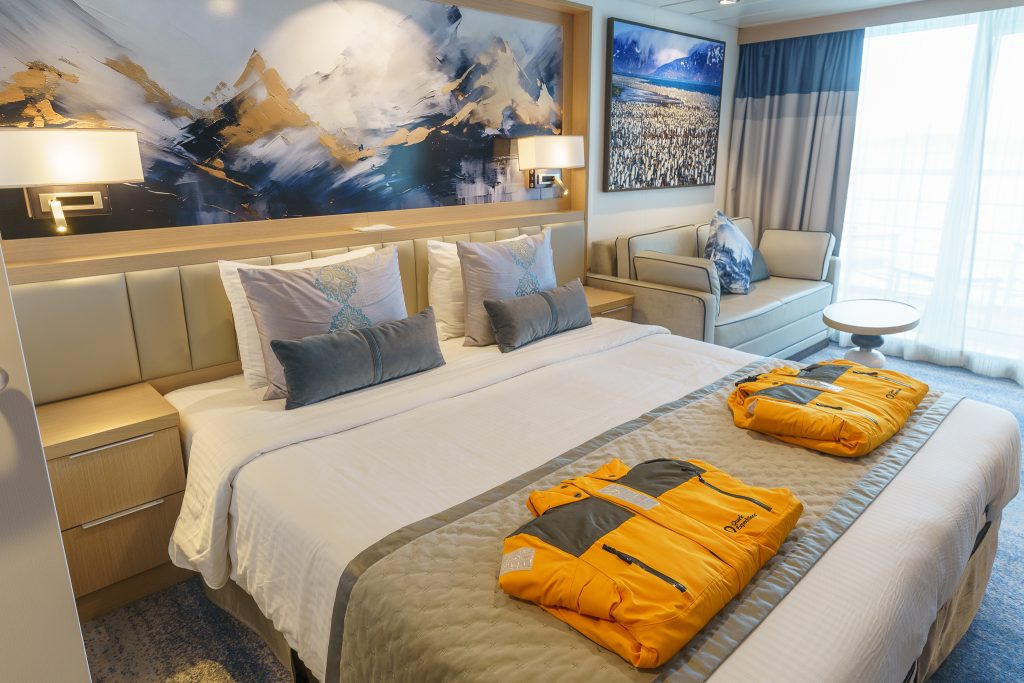 King bed with nightstands and yellow parkas on bed