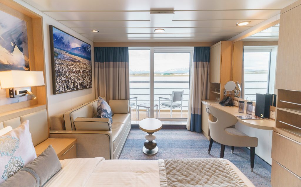 Veranda Suite with couch, desk & chair and sliding glass door