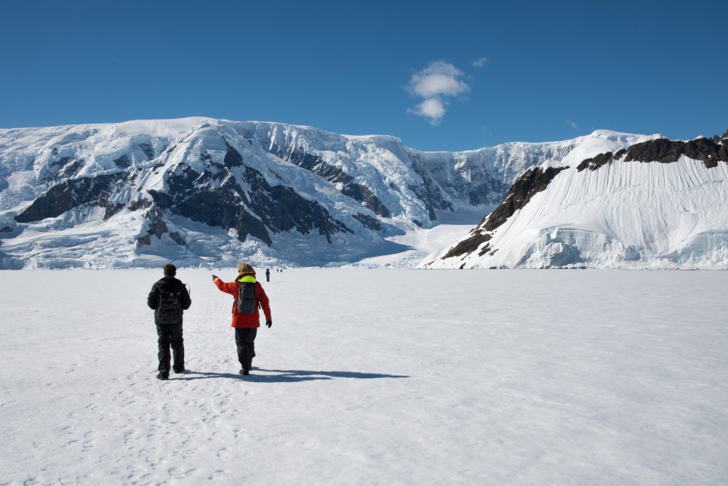 Guests walking on the fast ice in Wilhelmina Bay, Antarctica.