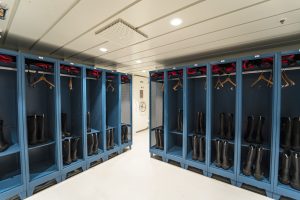 Blue lockers in the mudroom onboard Greg Mortimer