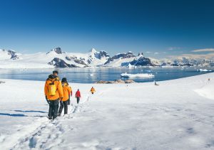 Guests walking on the snow in Antarctica.