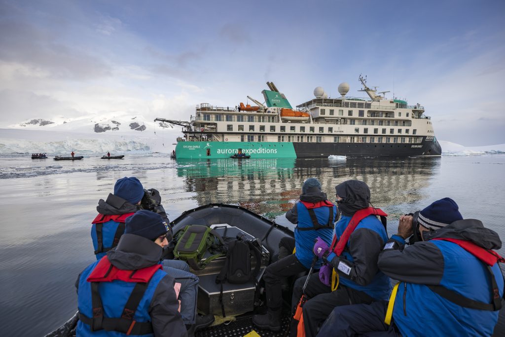 Passengers in zodiac with the ship Sylvia Earle in background.