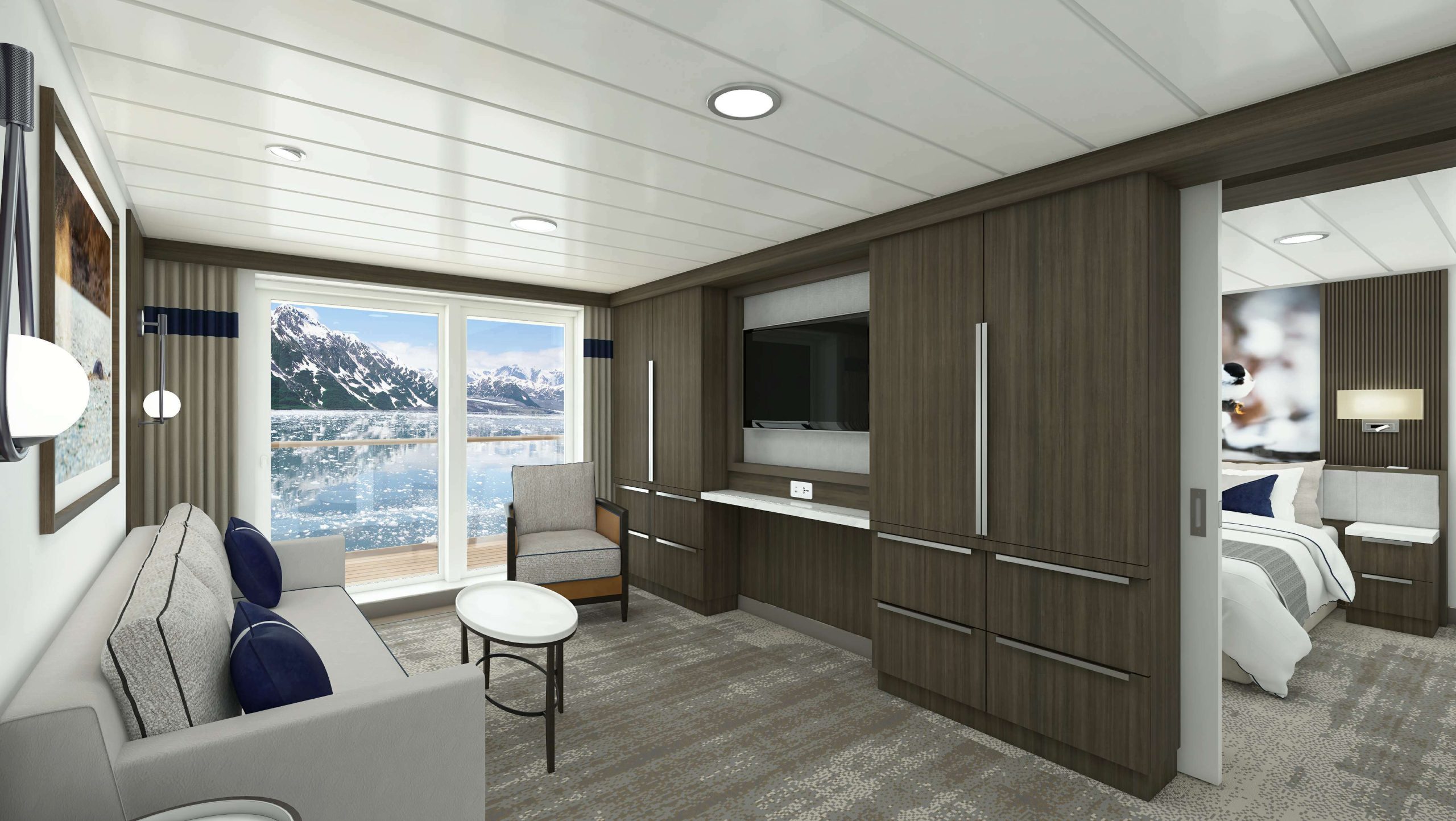 Living area with couch, tv and floor to ceiling windows in Captain's Suite on Douglas Mawson