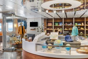 Gift shop onboard National Geographic Explorer displaying books, shirts, hats and globes