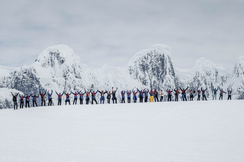 Snowshoers standing in a line on the snow.