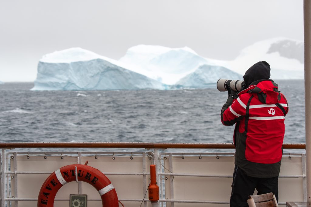 Guest photographic an iceberg from deck of ship.