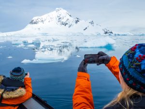 Guests photographing from a zodiac in Paradise Harbor, Antarctica.