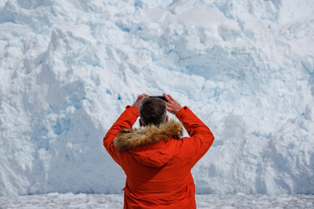 Solo traveler photographing the ice.